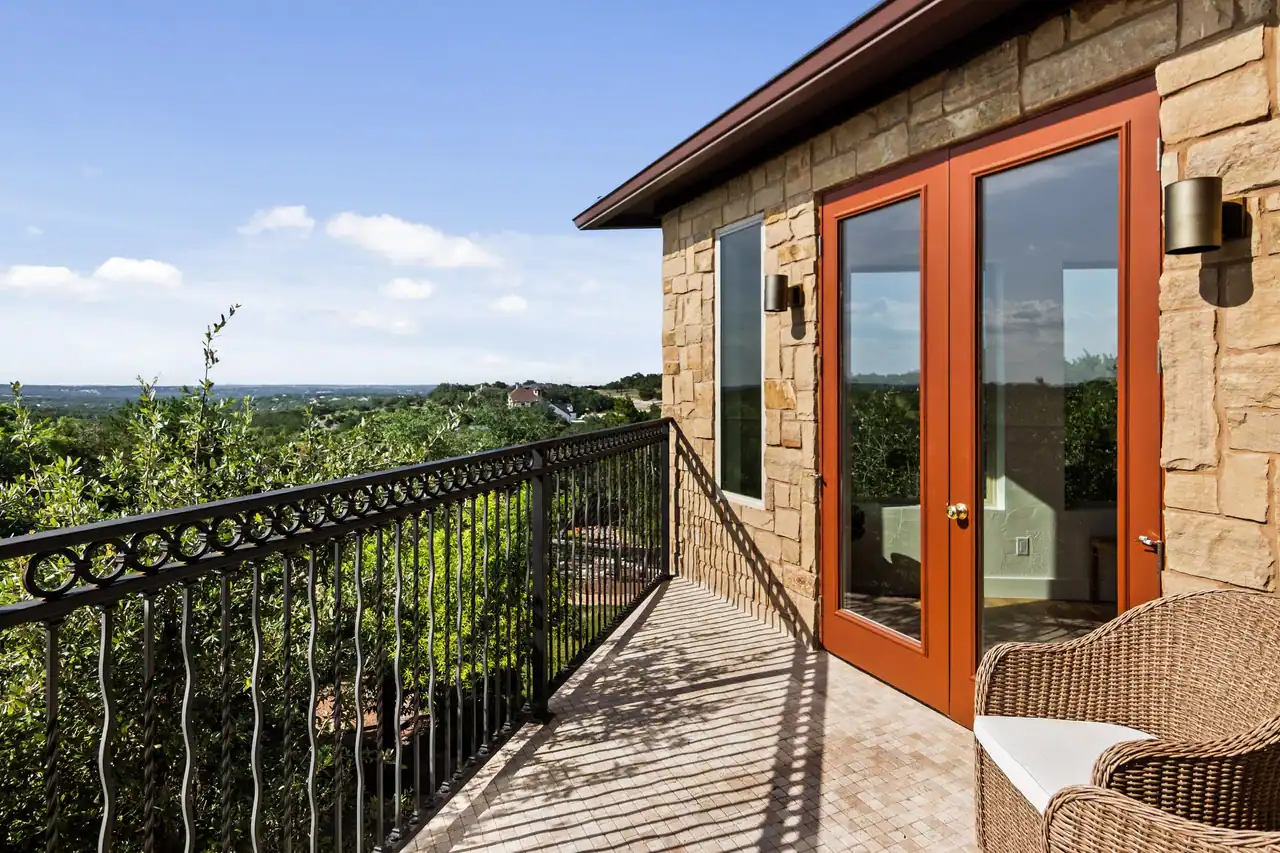 Covered balcony and Hill Country view at the Canyonwood guest house Ridge Rock built